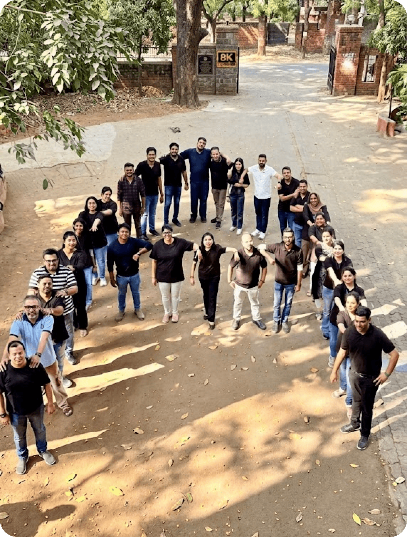 Jaimini Group team members standing in a V formation