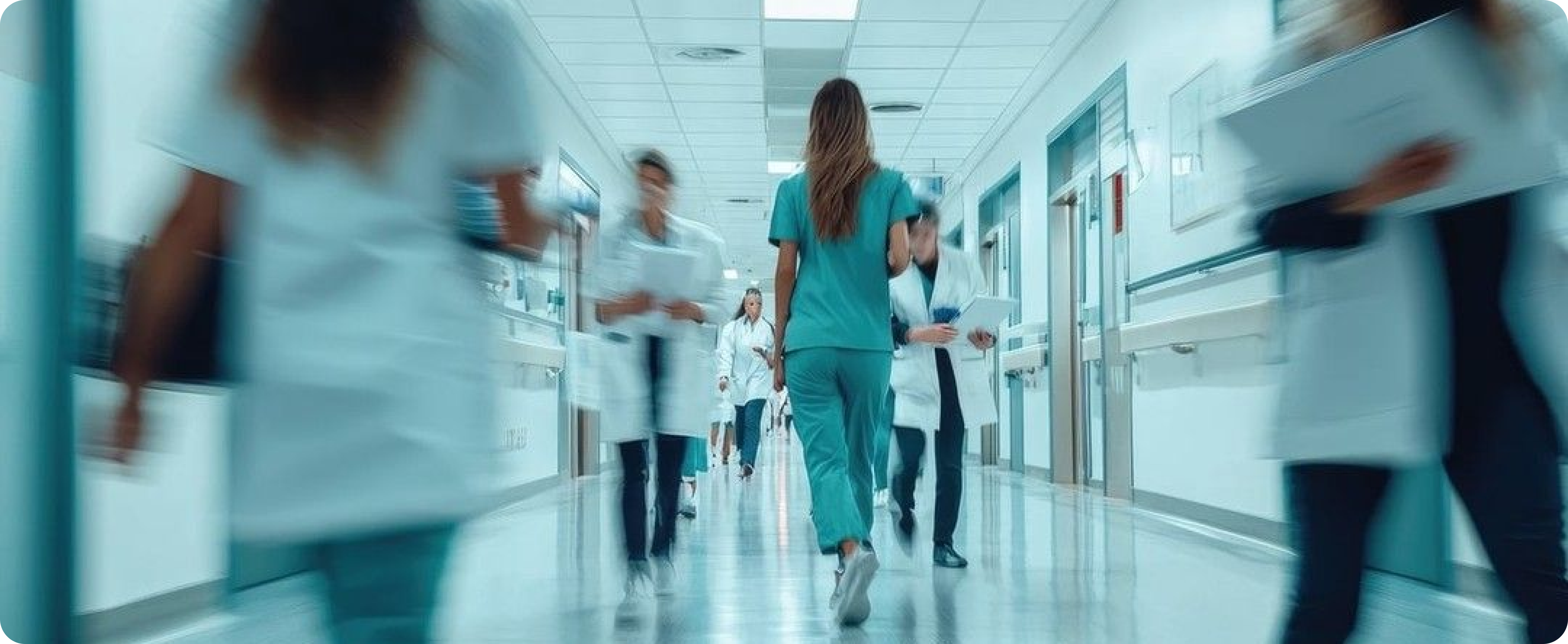 Health workers moving through a hospital corridor